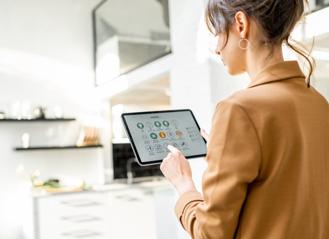 Home Cyber Insurance - Woman Using Her Tablet in the Kitchen