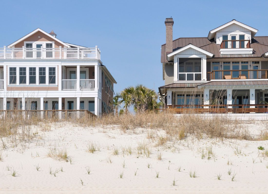 Secondary Home Insurance - Luxury Beach Front Vacation Home with Multiple Balconies and Dock in the Summer